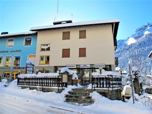 a building in the snow with snow on the steps at Apartment Apt 3 by Interhome in Canazei