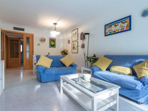 a living room with blue couches and a coffee table at Apartment Els Pins Maria by Interhome in Torredembarra