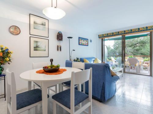 a dining room and living room with a table and chairs at Apartment Els Pins Maria by Interhome in Torredembarra