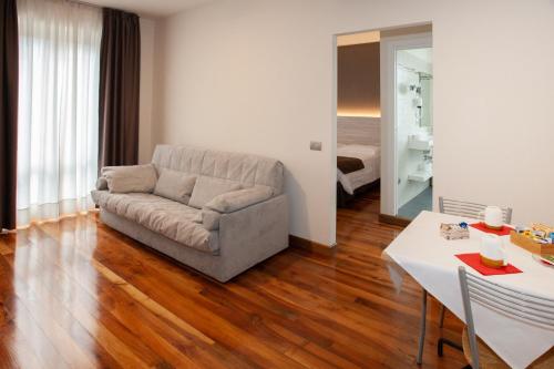 a living room with a couch and a table at Hotel Giardino in Bibbiena