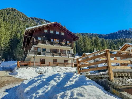 a building with snow in front of it at Apartment Roacia-2 by Interhome in Alba di Canazei