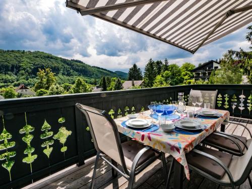 a table with plates and glasses on a balcony at Apartment Villa Marie by Interhome in Purkersdorf