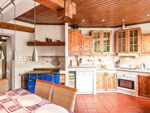 a kitchen with wooden cabinets and a table at Apartment Villa Marie by Interhome in Purkersdorf