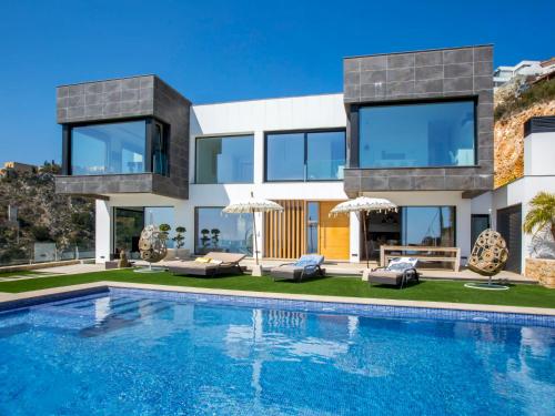 a house with a swimming pool in front of it at Villa Bali Infinity Plus by Interhome in Jávea