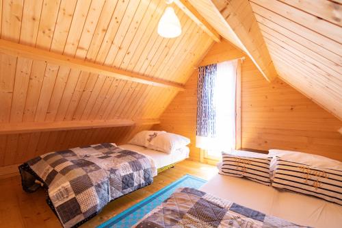 a bedroom with two beds in a log cabin at Marina in Jarosławiec