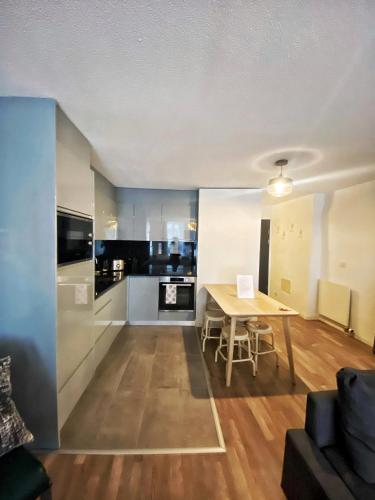 a living room with a table and a kitchen at Studio SIEVA in Lausanne