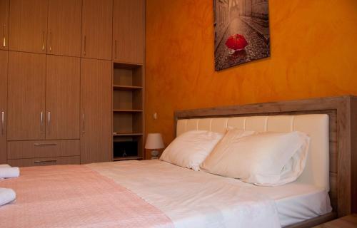 a bedroom with a bed with white pillows at Soureto's House in Liapades