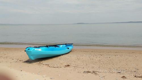 a blue boat sitting on the sand on the beach at Anchor Inn in Traverse City