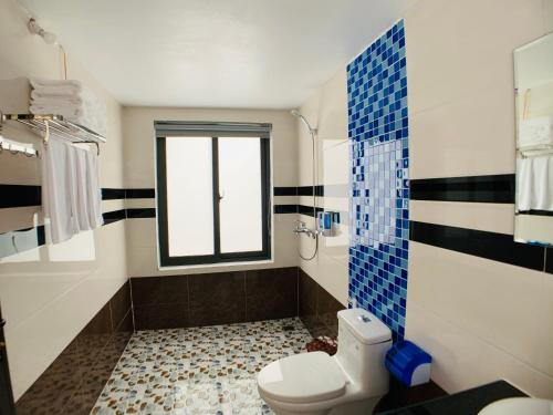 a bathroom with a toilet and a window at Trang An Peaceful Homestay in Ninh Binh