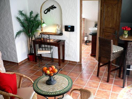 a room with a table with a bowl of fruit on it at Apartmenthaus Casa Palma in Bühl
