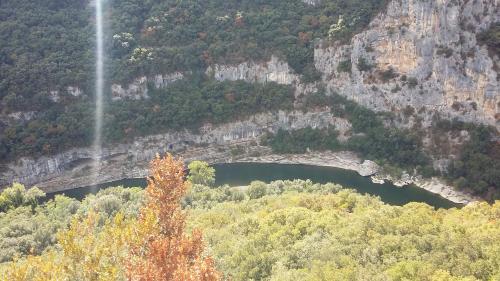 a view of a mountain with a lake in it at Chambre en Ardèche du Sud in Saint-Remèze