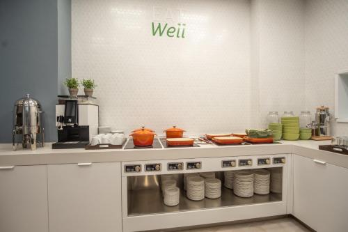 a kitchen with a counter with food on it at Holiday Inn Bucharest - Times by IHG in Bucharest