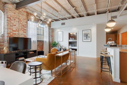 an open living room with a brick wall at Luxury Arts District Apartments in New Orleans