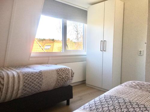 Postel nebo postele na pokoji v ubytování Bendalong Noordwijk