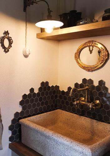a bathroom with a sink and a mirror on the wall at SelvaGiurata Farmhouse Villa in San Benedetto del Tronto