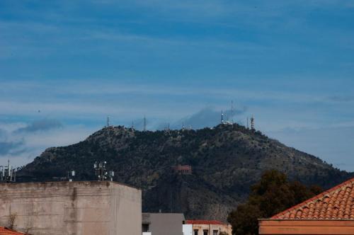 a mountain in the distance with houses and buildings at La Piccola Formica Charme Rooms in Palermo
