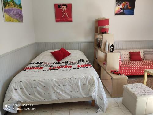 a bedroom with a bed and a chair in it at La Bedosse in Alès