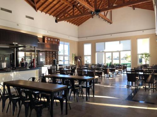 a dining room with tables and chairs in a restaurant at Howard Johnson Resort & Convention Center Ezeiza in Ezeiza