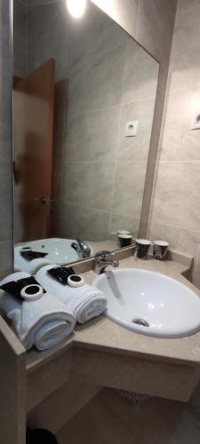 a bathroom with a sink and a mirror at Hotel Balcón de San Bartolo in Barreiros