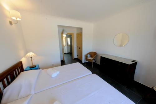 a bedroom with two beds and a desk and a mirror at Casa das Rendufas- Turismo Rural com Figos in Rendufas da Estrada