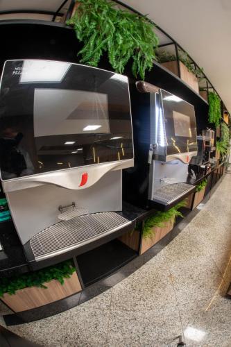 a room with a shelf with plants on it at Summit Hotel Monaco in Guarulhos