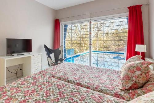a bedroom with a bed and a large window at LA ARMONIA in Córdoba