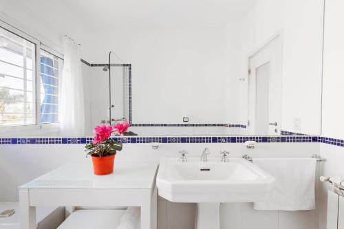 a white bathroom with a sink and a mirror at LA ARMONIA in Córdoba