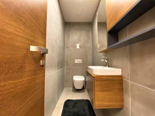 a small bathroom with a sink and a toilet at Apartman Romantika 13 Chopok juh Tale in Tale