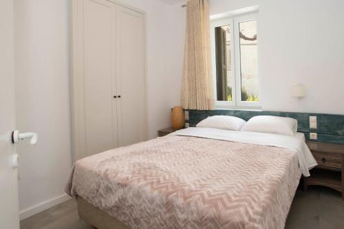 a bedroom with a bed and a window at Nestor's house in Pylos