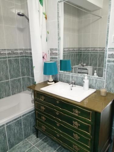 a bathroom with a sink and a mirror at CASA DAS PEDREIRAS in Peso da Régua