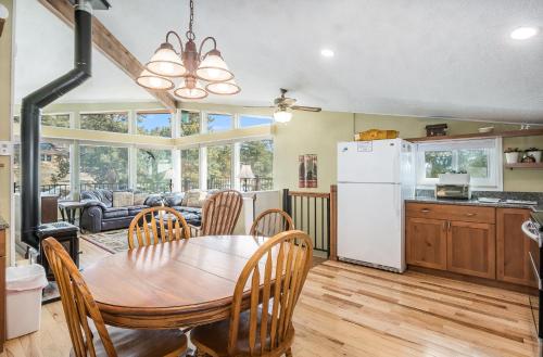 a kitchen and dining room with a table and chairs at Starlight In The Rockies in Estes Park