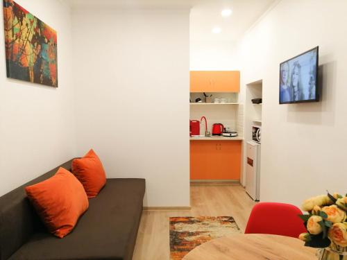 a living room with a couch and a kitchen at Apartments in the city center in Lviv