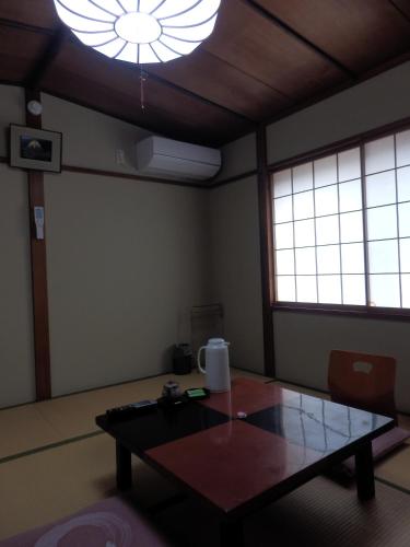 a room with a table and a large light at Kikunoya Ryokan in Kanazawa