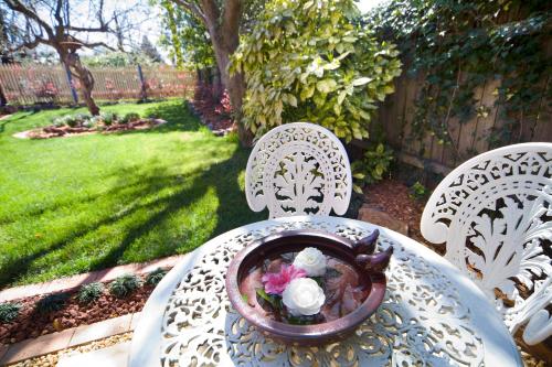 a table with a bowl of flowers on top of it at Mountain Whispers Varenna Luxury in Leura