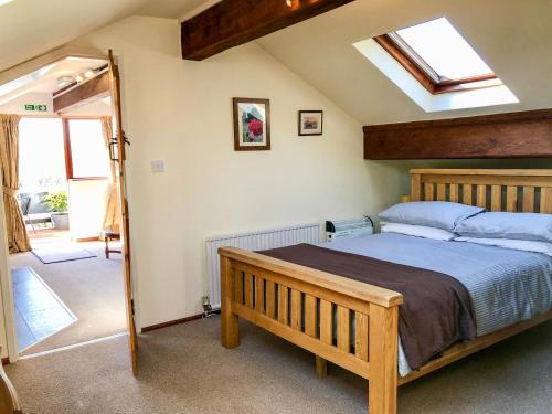 a bedroom with a bed and a skylight at Heather in Ruthin