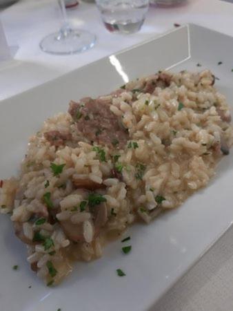a plate of food with rice on a table at B&B Brezza Marina & Ristorante Shoreline in Pozzallo