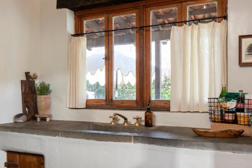 a kitchen counter with a sink and a window at Casa Cody in Palm Springs