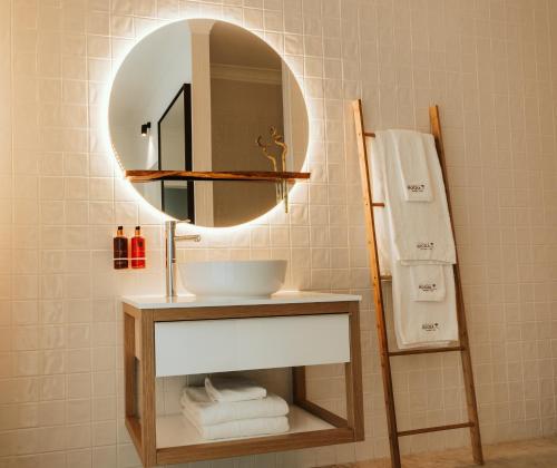 a bathroom with a sink and a mirror at Herdade da Rocha - Boutique Lodge in Crato