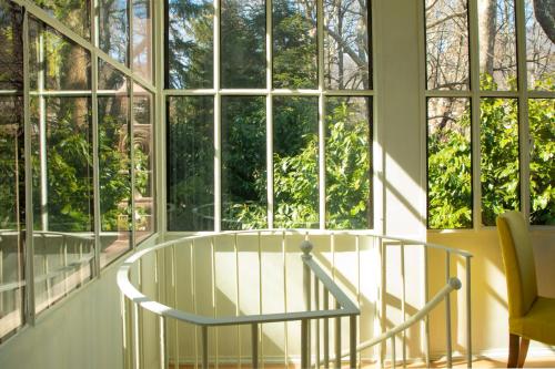 a room with large windows and a glass table at Villino liberty in Cernobbio