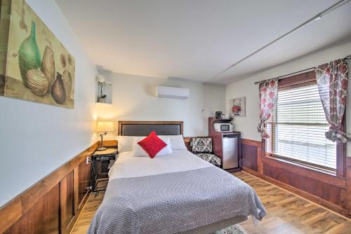 a bedroom with a bed with a red pillow on it at Cozy Ellsworth Home with Yard, 15 Mi to Acadia! in Ellsworth
