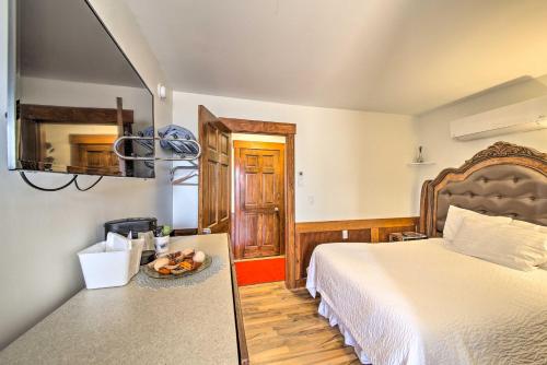 a bedroom with a bed and a bowl of fruit on a table at Cozy Ellsworth Home with Yard, 15 Mi to Acadia! in Ellsworth