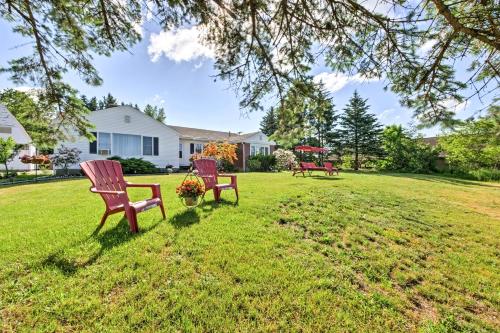 three chairs sitting in the grass in a yard at Cozy Ellsworth Home with Yard, 15 Mi to Acadia! in Ellsworth