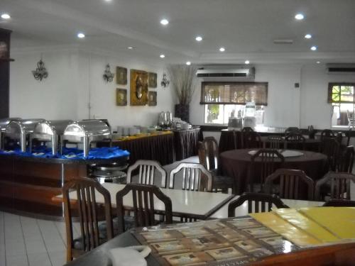 a dining room with tables and chairs in a restaurant at Hotel Seri Malaysia Port Dickson in Port Dickson