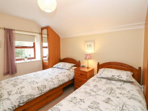 En eller flere senge i et værelse på Lavender Cottage