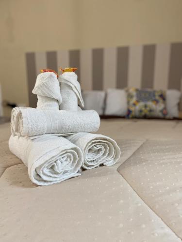 a pile of towels on the floor in a room at La Piccola Formica Charme Rooms in Palermo