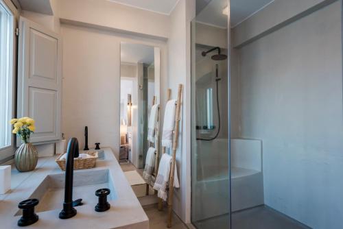a bathroom with a glass shower and a sink at Bohemian Blue Villa - 7 BDRM - beach in 200m - MG Villas in Panormos Mykonos
