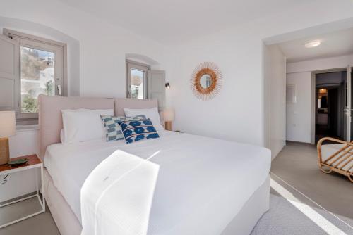 a white bedroom with a white bed and a mirror at Bohemian Blue Villa - 7 BDRM - beach in 200m - MG Villas in Panormos Mykonos