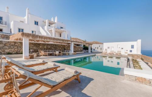 a villa with a swimming pool and a resort at Bohemian Blue Villa - 7 BDRM - beach in 200m - MG Villas in Panormos Mykonos