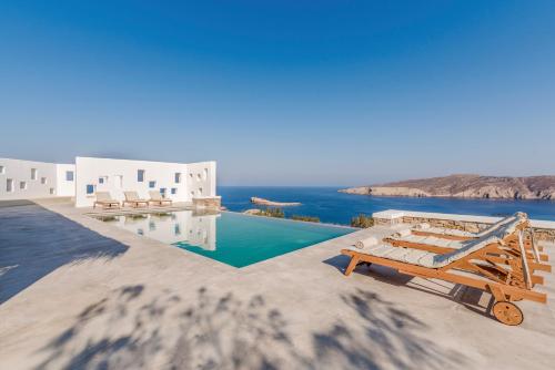 a resort with a pool and a view of the ocean at Bohemian Blue Villa - 7 BDRM - beach in 200m - MG Villas in Panormos Mykonos