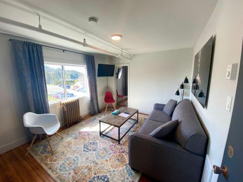 a living room with a couch and a table at The Maq Hotel in Tofino